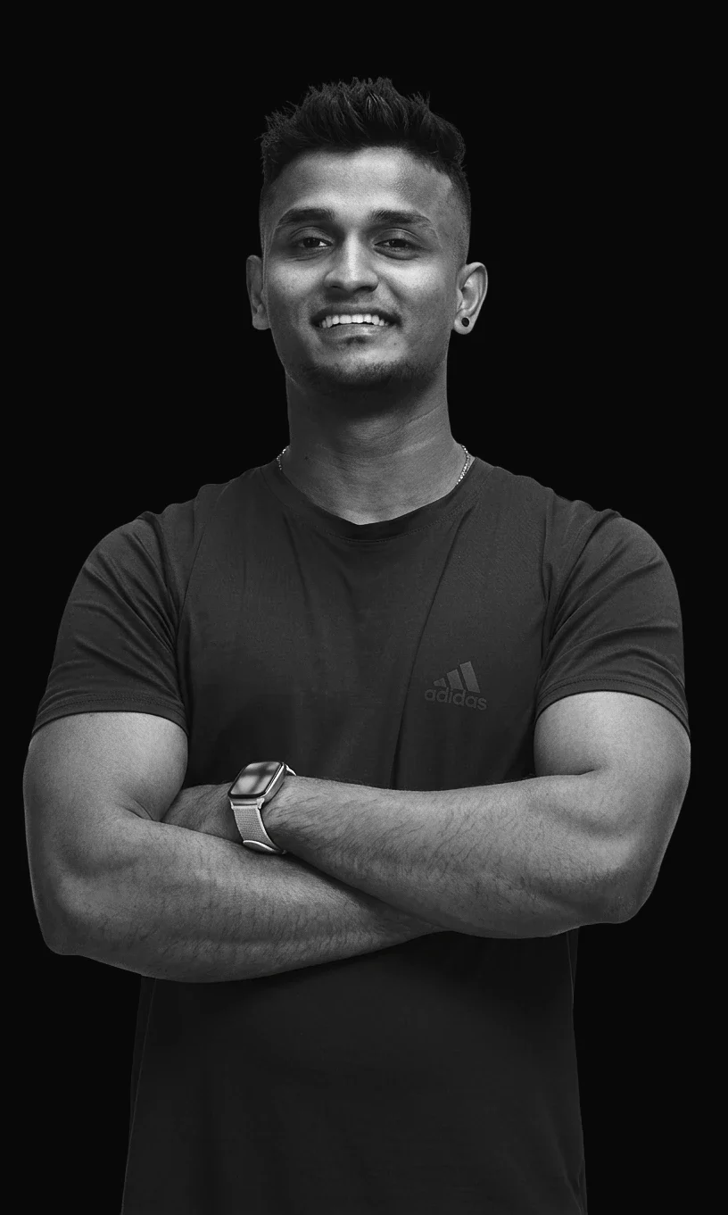 Akhil, personal trainer, smiling with his arms crossed